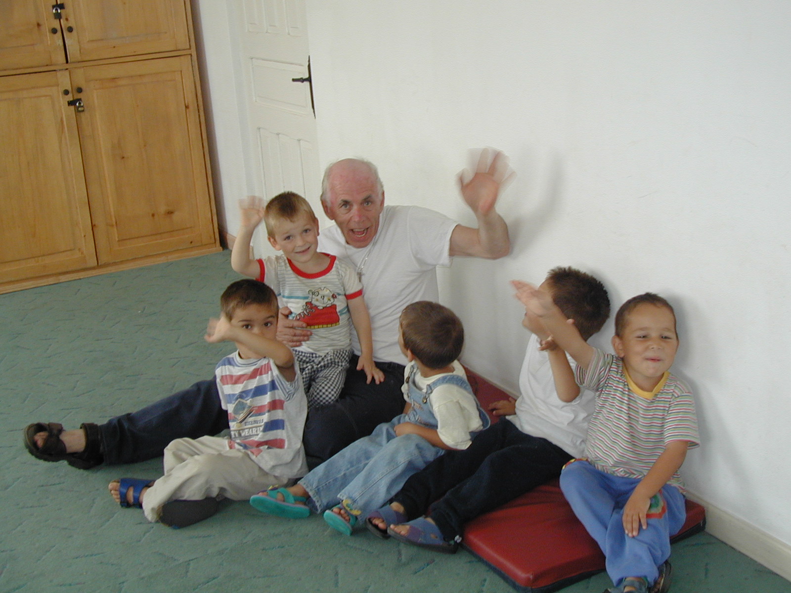 Another photo of Fr. John with children in the playroom at the orphanage.